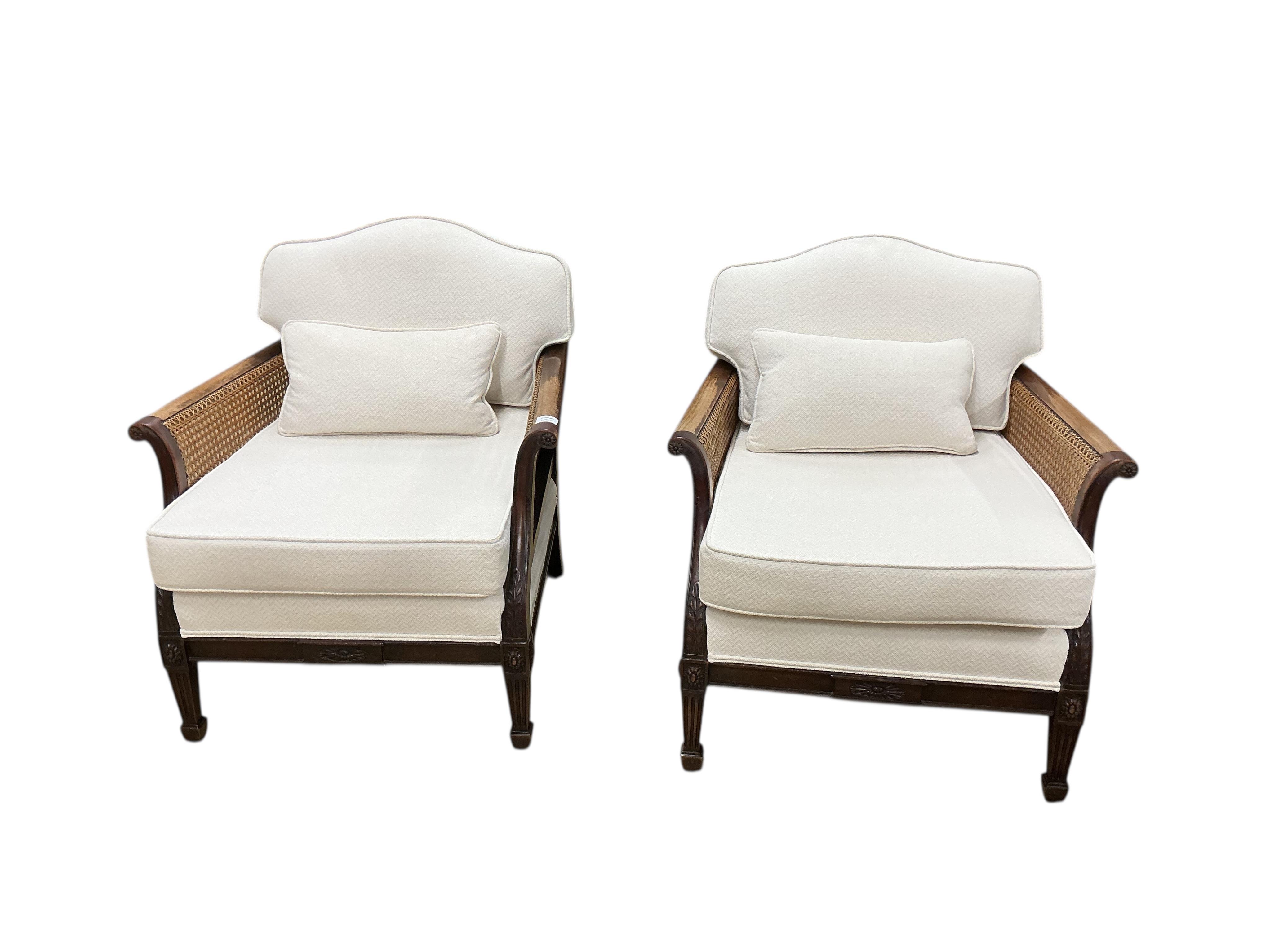 A pair of early 20th century mahogany bergere armchairs, width 75cm, depth 78cm, height 80cm